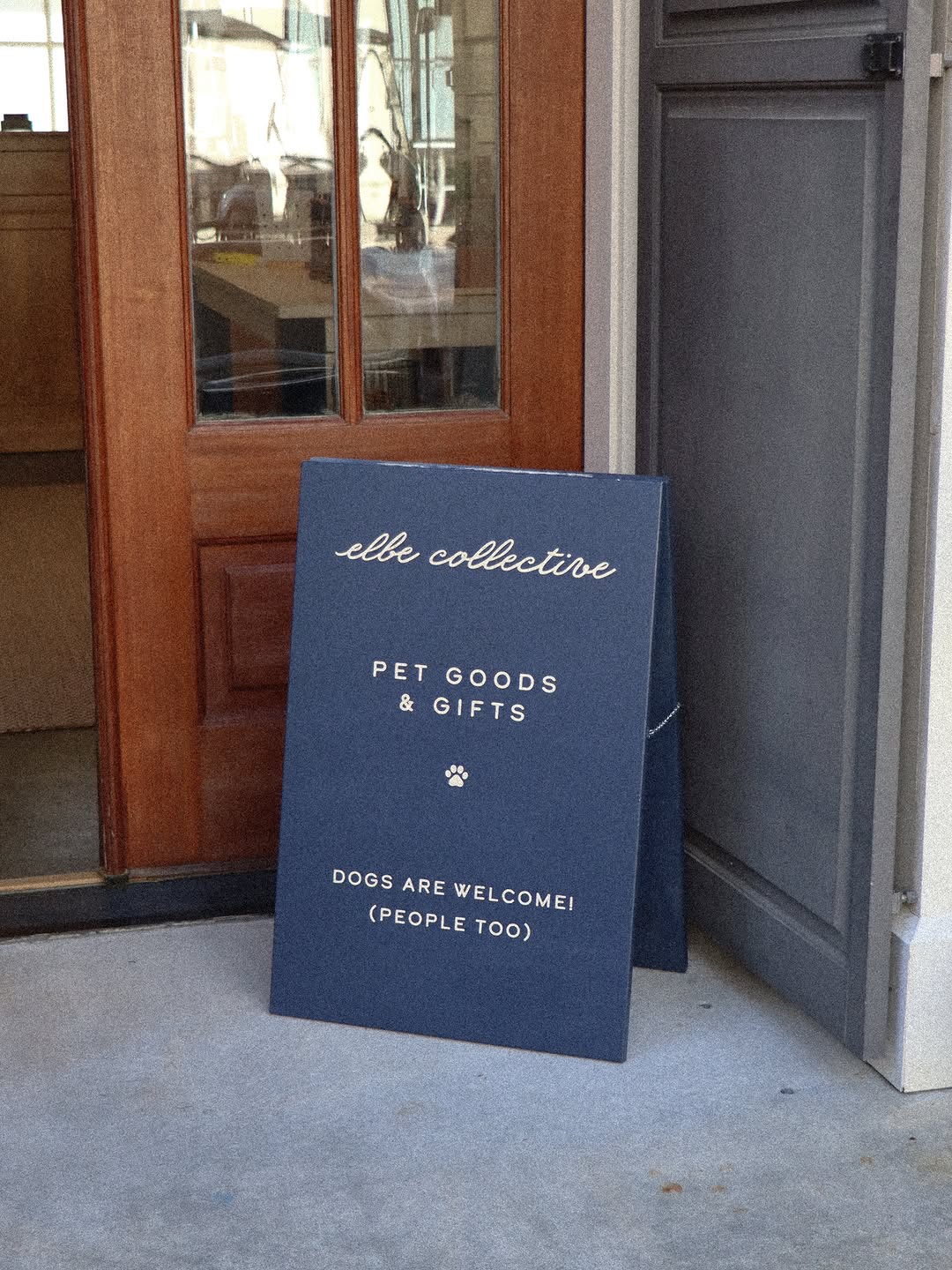 The Elbe Collective sign at the shop door: pet goods and gifts, dogs are welcome, people too