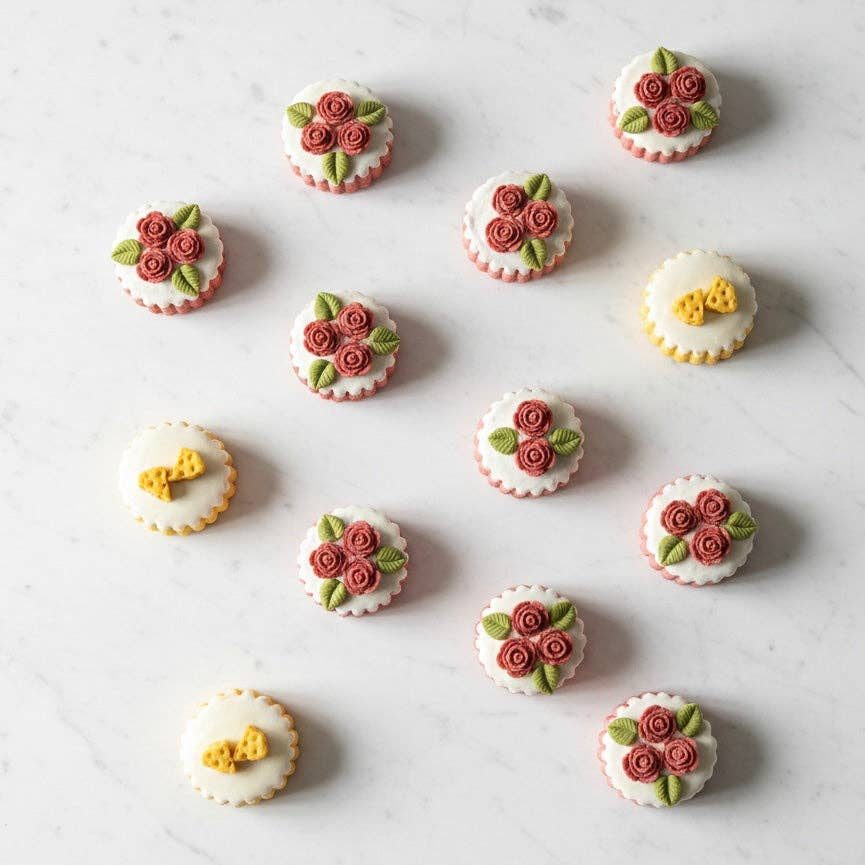 Mini bakery cakes for dogs and cats laid out on marble