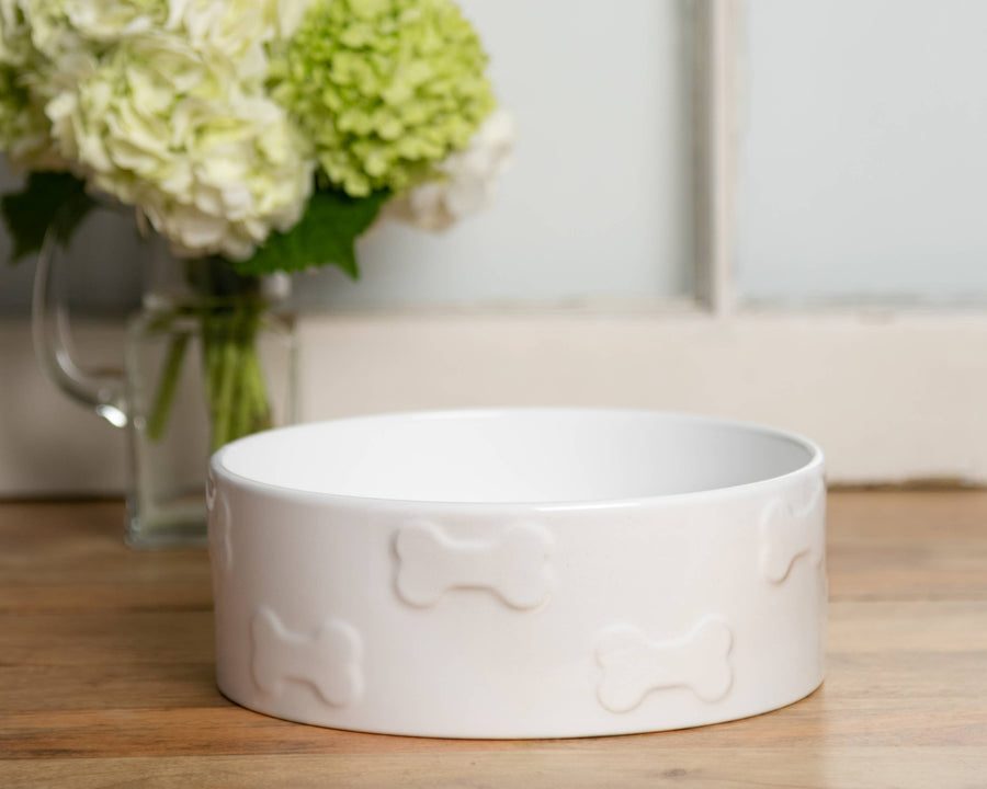 A Manor ceramic pet bowl set out on a kitchen rug